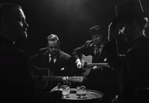Band playing in their black and white music video.